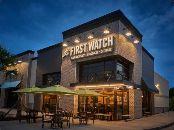 A First Watch restaurant exterior at dusk.